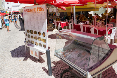 A restaurant menu alongside a fish selection