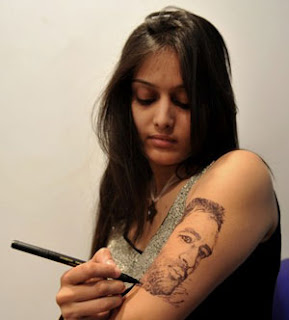 Artist Yogita Panchal gives the final touches to a tattoo of Mahendra Singh Dhoni at the India Ink Tattoo Convention in Mumbai.