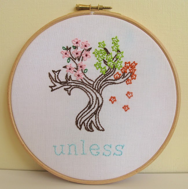 embroidered tree with leaves representing different seasons and the word unless stitched underneath