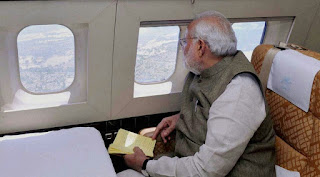 MODI SITTING ON A FLIGHT