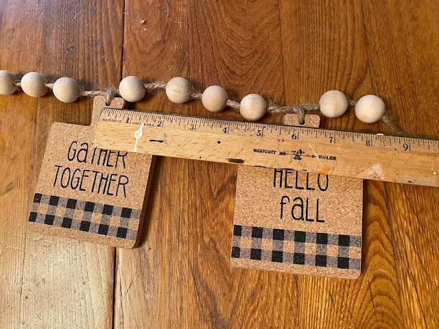 Photo of making a banner with beads and coasters.