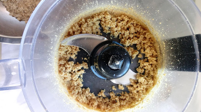 a food processor filled with finely chopped walnuts