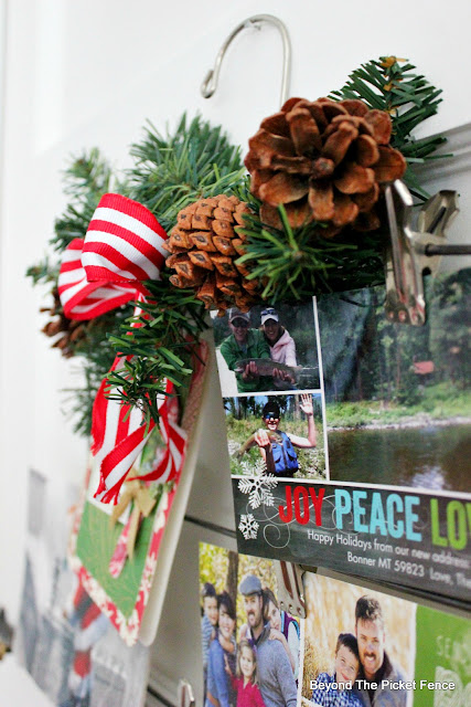 add a pine bough to a hanger to make a Christmas card holder