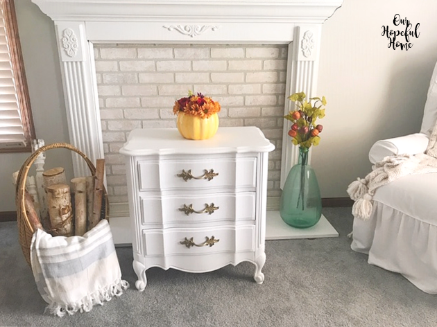 white painted vintage nightstand white birch logs basket striped throw