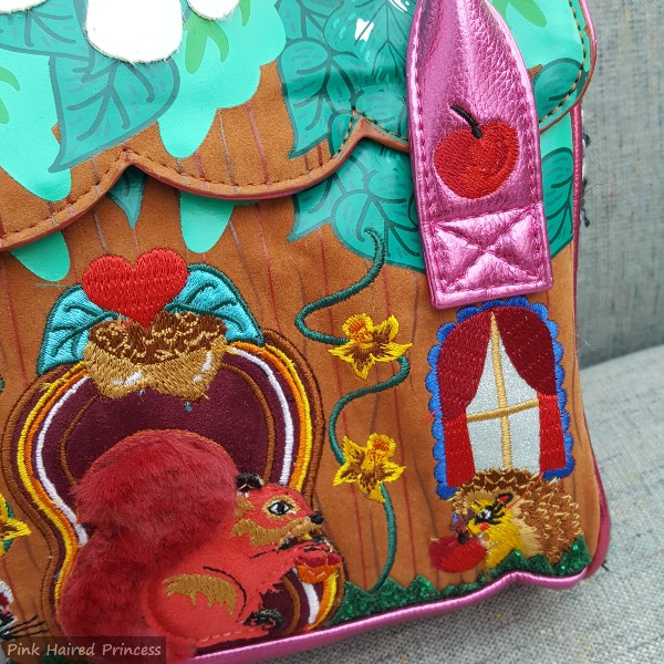apple and hedgehog embroidery on front of cabin themed handbag