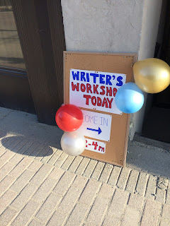 Sign with balloons that says writer's workshop today