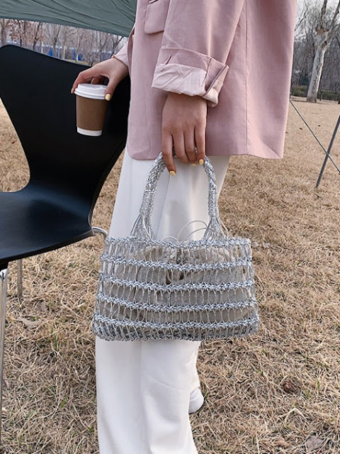 A woman has a new beach weaving design handbags.