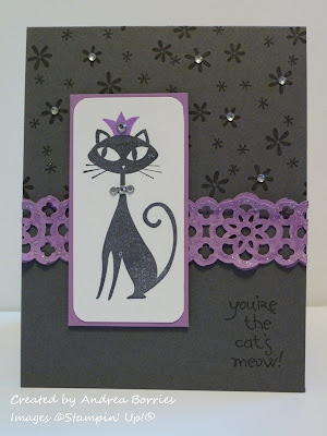 Gray card with flowers stamped on background. Focal image is black cat with a rhinestone collar and purple crown. Sentiment reads "you're the cat's meow!"