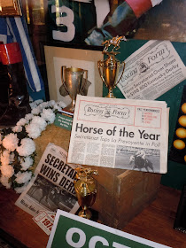 Secretariat trophy and newspaper props