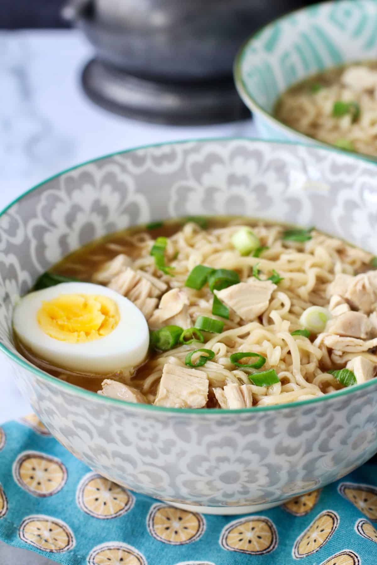 Rotisserie Chicken Ramen sprinkled with scallions in two bowls.