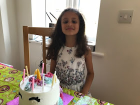 Child with a unicorn birthday cake
