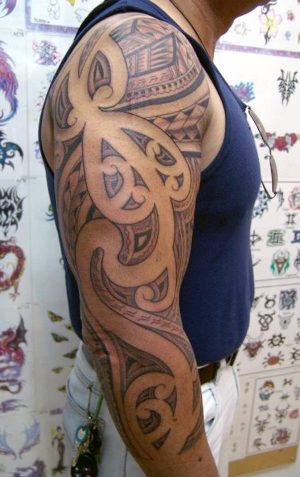 It looks really so amazing samoan tribal tattoos design dark black work on the man’s arm