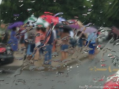 People standing in the rain. Copyright by Michelle Jones Online.