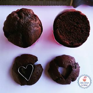 Cutting chocolate cupcakes and cutting out heart shapes.