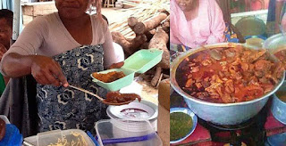 African restaurant, public food,  the image contains an African lady sharing food
