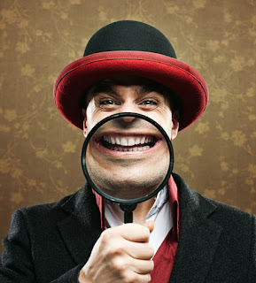 Comedian holding up a magnify glass