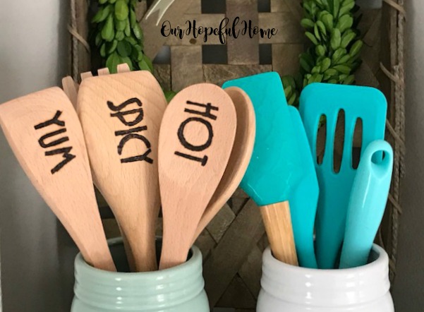 engraved wooden spoon spatula cooking kitchen mason jar boxwood wreath turquoise tools