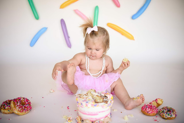 Using her toes for a cake smash