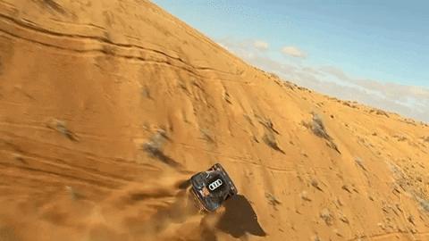 Off-road vehicles racing in Dakar Desert Rally.
