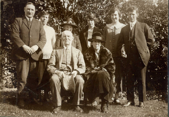 A group of 6 standing and 2 seated people