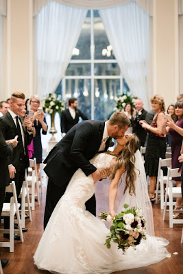 bride and groom kiss at ceremony