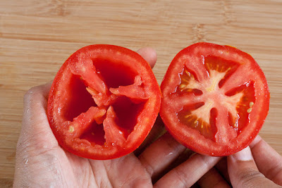 Halved tomato with seeds and without