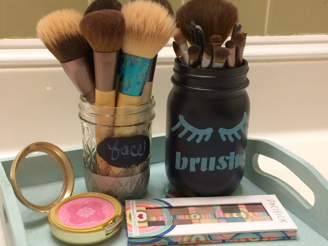 I used chalkboard paint and glitter vinyl to re-purpose mason jars into decorative holders for my makeup brushes.