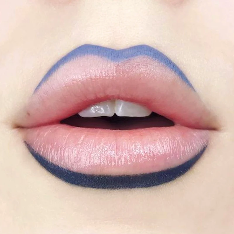 close-up of woman's lips with a nude lip look and dark outlining