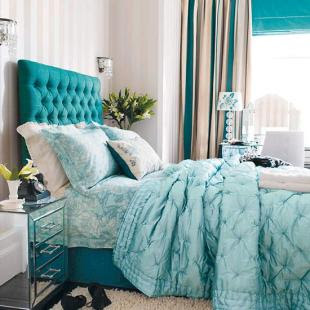 Bedroom with stripe wallpaper and buttoned headboard