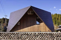 Origami House Design with A-Frame in an Old Village Surrounded by Mountains