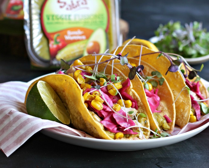 Recipe for tacos made with cumin grilled chicken, guacamole and pickled cabbage.