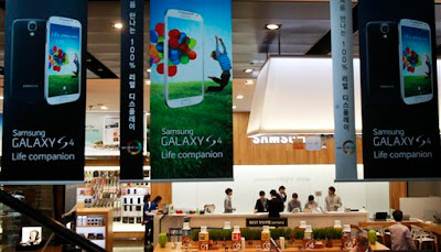 Banners advertising Samsung Electronics' Galaxy S4 smartphones are displayed at a showroom of its headquarters in Seoul, South Korea, Friday, April 26, 2013. Samsung Electronics Co. said Friday its first-quarter net income jumped to a record high because sales growth in smartphones continued even before the launch of the Galaxy S4 during a typically slow season for the electronics market. (AP Photo/Ahn Young-joon)