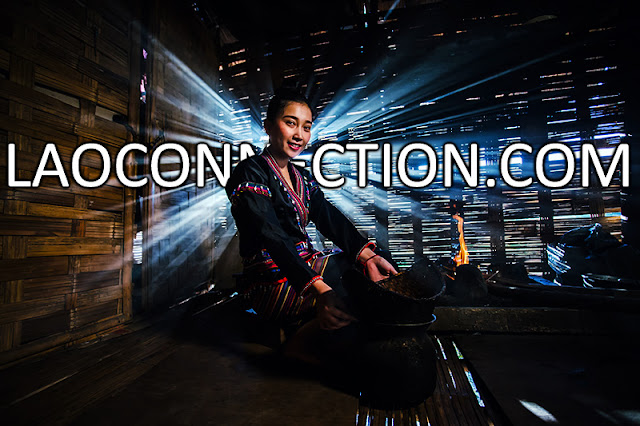 Looking fabulous while cooking in her bamboo kitchen with an open fire stove. This is how Lao girls do it.