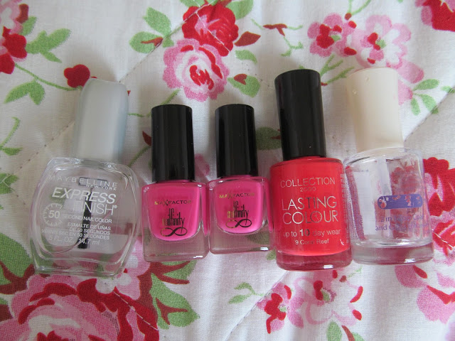 large clear top coat, two small hot pink nail polish bottles, coral bottle, clear top coat