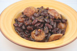 How to make Boston Baked Beans in the crockpot slow cooker. Brown sugar, kidney beans, onions, sausage, molasses -- great for a backyard party side dish.