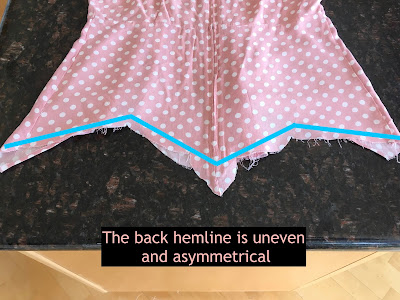 Polka dot top with bright blue lines on the back view to show where to angle the hemline in the back.