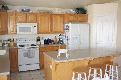 Yellow Kitchen Appliances on Cabinets  White Tile  White Appliances  Blue And Yellow Accessories