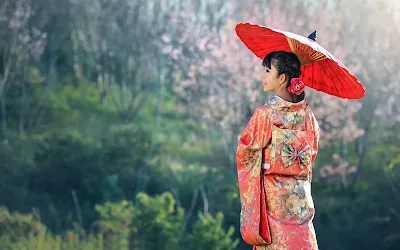A japanese girl holding an umbrella