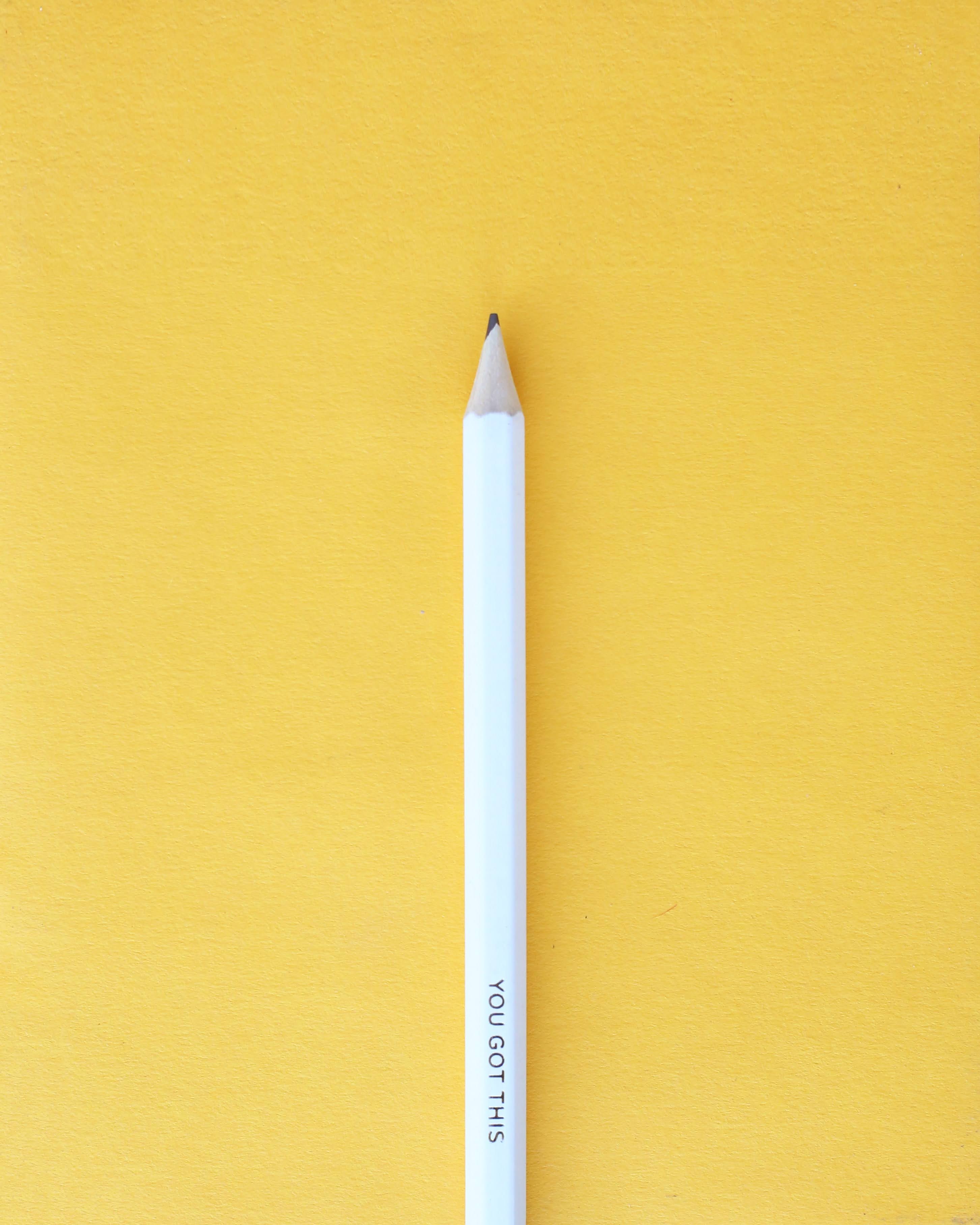 White Pencil on Yellow Background | Photo by The CEO Kid via Unsplash