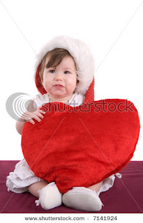 baby wishing happy valentines day with a heart