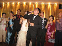 Chris, the bridegroom performing the toast or yam seh