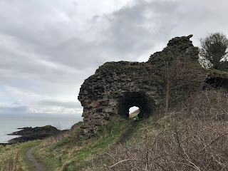 A photo of an old, stone ruin beside the sea.  There is a curved passageway leading through it.  This is the ruin of the lime kilns at Tickleness Point.  Photograph by Kevin Nosferatu for the Skulferatu Project.