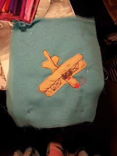 2. The plane is sewed down and the details are added in with embroidery including the sparrow and shading