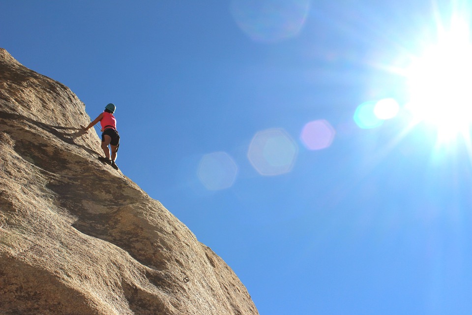 Man climbing sloping mountain