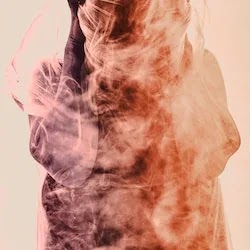 postpartum depression. A photo of a person looking dejected and enveloped in smoke