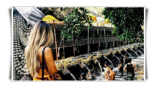 Picture of a woman enjoying the view of The Holy Water Spring of Tirta Empul - Bali Male Escort Service