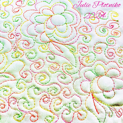 Multcolored machine stitching of flowers, leaves and swirls