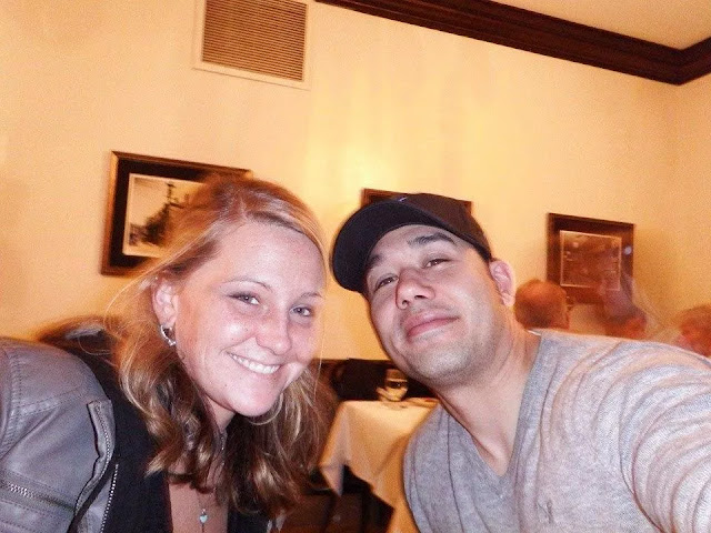 This selfie photo of the couple who is having dinner should be surprised by the woman behind them