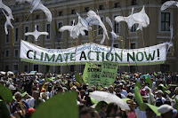 People hold a banner reading ' Climate action Now ' in St. Peter's Square, at the Vatican, Sunday, June 28, 2015. Voters in key swing states like Iowa say they agree with Pope Francis about climate action. (Photo Credit: AP/Andrew Medichini) Click to Enlarge.