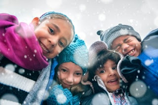 Group of youth smiling outside as it snows
